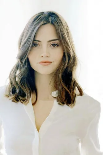 Try on this wavy, medium-length hairstyle in a subtle brown tone, flowing naturally with gentle waves that soften the facial features.