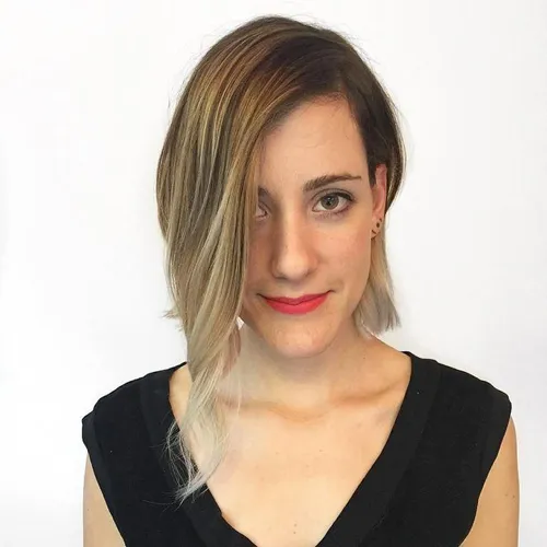 Try on this stylish asymmetrical bob hairstyle featuring an ombre color transition from dark brown to blonde.