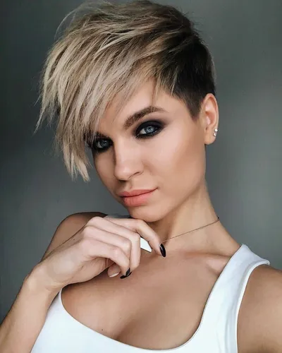 Try on this stylish short asymmetrical haircut, featuring a longer fringe on one side that gradually shortens to a closely cropped cut on the other side.
