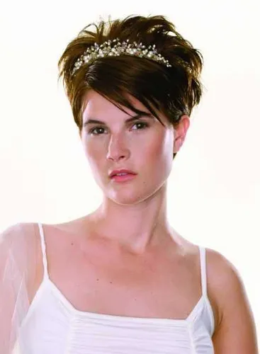 Try on a styled updo hairstyle accentuated with a tiara, ideal for elegant events.
