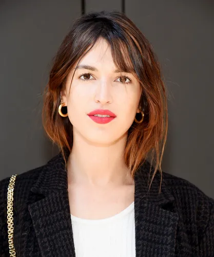 Try on a medium-length, shaggy hairstyle with a casual chic look and soft, textured bangs framing the face.