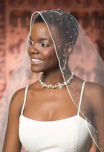 Try on this chic short hairstyle, ideal for showcasing elegant features and accessories like a delicate veil and necklace