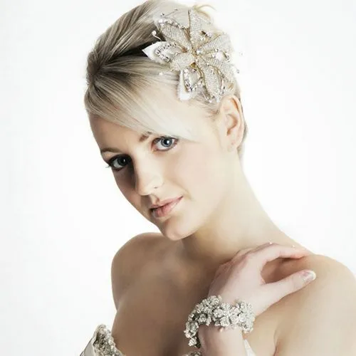 Try on this elegant blonde updo hairstyle, featuring a prominent embellished hair accessory and styled to showcase a neat, polished look suitable for formal occasions.