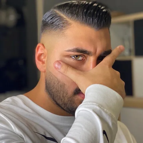 Try on a slicked back hairstyle with a neat side part, featuring well-groomed, shiny hair combed away from the face, showcasing a defined, smooth texture.