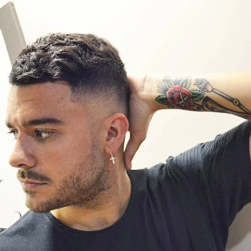 Try on a stylish men's hairstyle featuring a short curly top with a clean fade on the sides, ideal for a sharp, modern look.