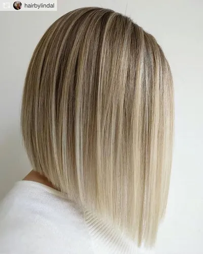 Try on this sleek blonde bob cut hairstyle, featuring neatly trimmed ends and subtle highlights ranging from deeper blonde roots to lighter tips, ideal for a smooth and uniform look.