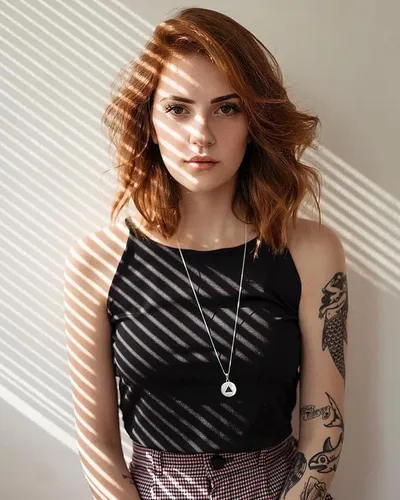 Try on this medium length wavy hairstyle with warm tones of auburn and ginger that give a vibrant, youthful look.