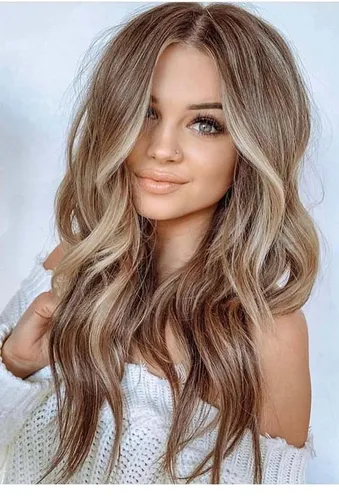 Try a beautifully styled wavy, long hairstyle with highlighted brunette tones.