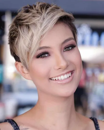 Try on this trendy short haircut with textured layers and blonde highlights.