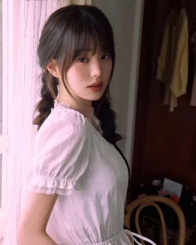 try on a cute braided hairstyle with wispy bangs covering the forehead