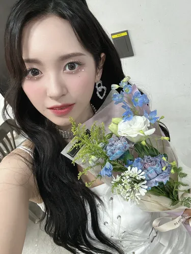 Try on this elegant hairstyle featuring long black hair with curly ends. The person is facing forward, showing a detailed hairstyle that cascades beautifully over her shoulders.