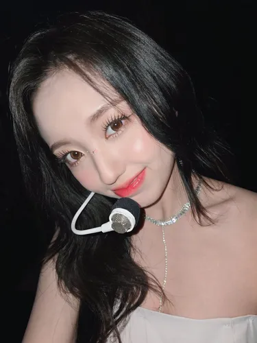 Try on a deep black, long wavy hairstyle with a glossy finish and natural volume.