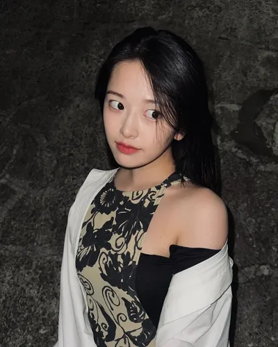Try on a long black hair look with smooth texture and a slight wave, complementing a gentle and youthful style.