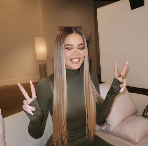 Try on this long straight hairstyle, featuring sleek, smooth texture that transitions from darker roots to lighter tips, resembling an ombre effect.