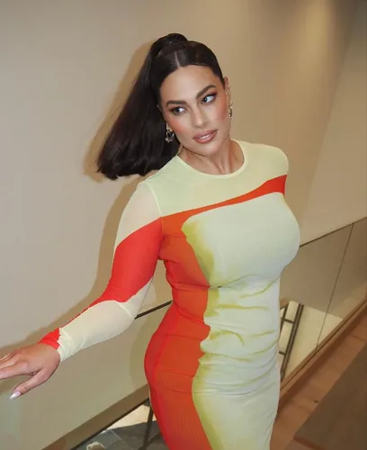 Try on this sleek high ponytail hairstyle, which adds an elegant touch to the overall look.