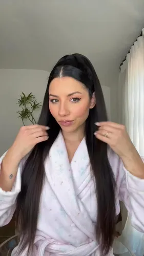 Try on the sleek and straight hairstyle with a center part. The hair falls smoothly past the shoulders, offering a polished and simple look.