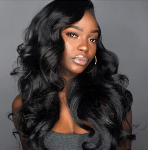 Try on this gorgeous long wavy dark hairstyle that elegantly frames the face with voluminous, luscious curls