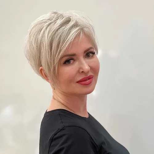 Try on this chic short textured hairstyle with layers that add volume, showcased here on a woman facing slightly sideways.