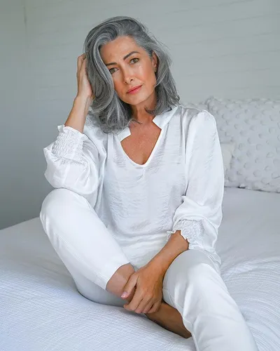 Try on this elegant long, wavy grey hairstyle perfect for adding a touch of grace and sophistication.