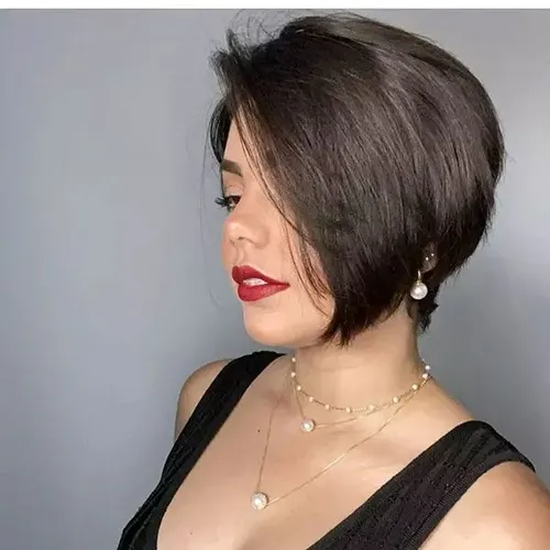 Try on a chic bob hairstyle, featuring sleek, dark brown hair cut at jaw-length with a slight inward curve around the face, creating a soft, elegant look. Ideal for showcasing facial features.