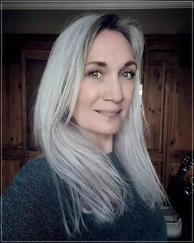 Try on this sleek and straight long hairstyle in a soft silver color, offering a chic and polished look.
