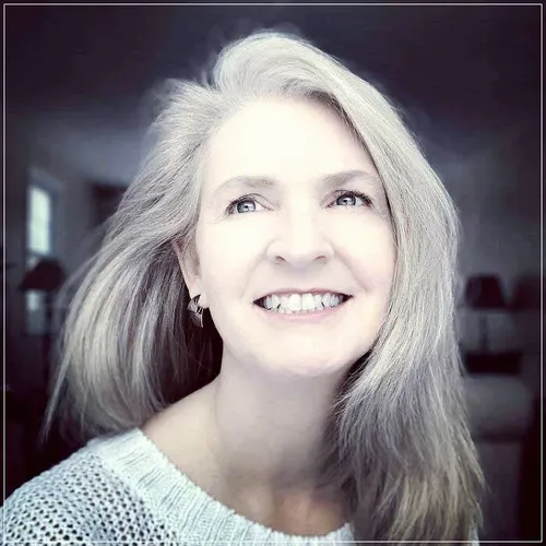 Try on this elegant long gray hairstyle, featuring softly flowing strands that frame the face gently, adding a graceful air.