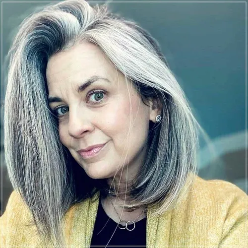 try on a trendy medium length gray hairstyle with smooth texture and a natural look. This style accentuates a youthful essence while displaying elegance.