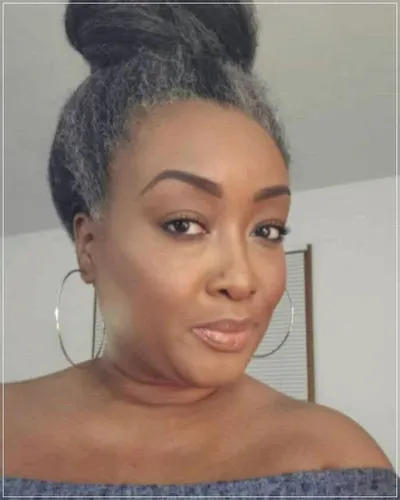 Try on this sophisticated top bun hairstyle, featuring sleek sides and a textured bun atop the head, suitable for both casual and formal settings.