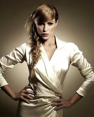 try on this elegant side-swept braided hairstyle that merges sophistication with a touch of chic edge