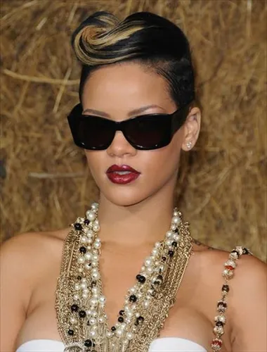 Try on a sophisticated updo hairstyle with elegantly swept hair with blonde and black highlights