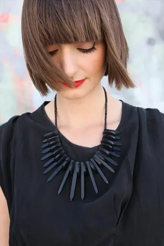 Try on a modern bob cut with a straight fringe. This hairstyle is characterized by even length and precise, straight-across bangs that cover the forehead, adding a contemporary and stylish flair.