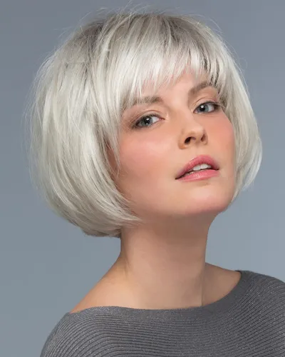 Try on this trendy short blonde bob hairstyle with soft bangs, perfectly framing the face for a modern and stylish look.