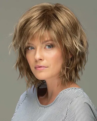 Try on this trendy shaggy haircut with messy layers and fringe that softly frame the face, ideal for adding texture.