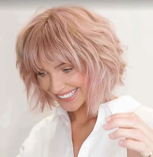 Try on this playful pink, short wavy hairstyle perfect for a fresh and youthful look.