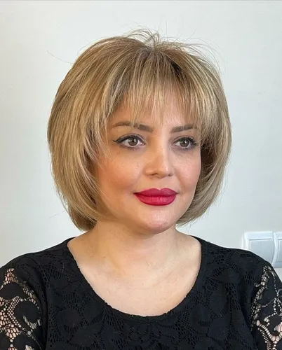 Try on a blonde bob hairstyle with bangs, featuring a layered cut that softly frames the face