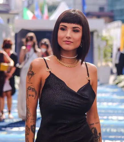 Try on this sleek bob cut hairstyle, characterized by its even length all around, complementing her straightforward gaze. The hair is styled in a smooth, straight manner that covers the forehead just above the eyebrows.