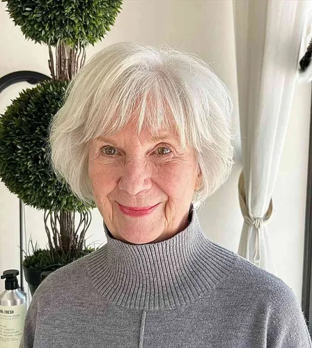 Try on this sophisticated short white hairstyle on a smiling elderly woman.