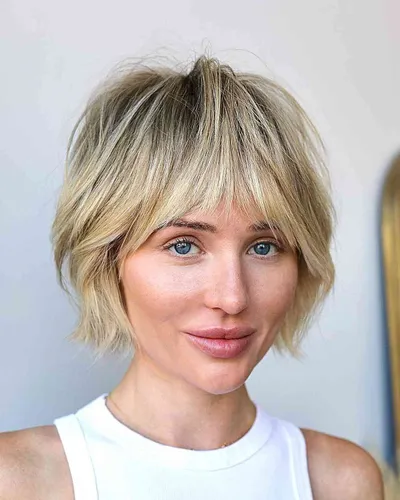 Try on this trendy shaggy bob hairstyle with blonde highlights, featuring short, uneven layers and choppy ends that give a playful and modern look.