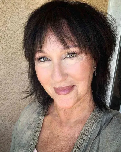 Try on this sophisticated short and layered hairstyle, styled with volume at the crown and slightly tousled strands that softly frame the face, enhancing a youthful and elegant look.