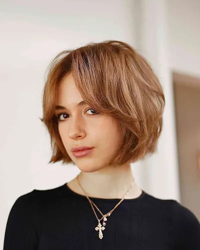 Try on a stylish short wavy bob hairstyle, featuring soft waves that add texture and a youthful look.