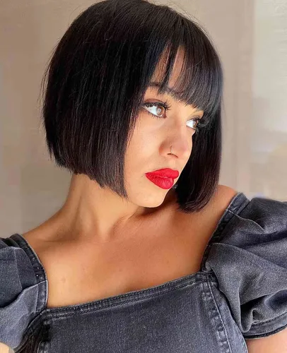Try on this sleek bob cut with straight bangs across the forehead, highlighting a chic and modern hairstyle choice.