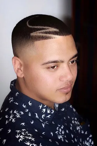 Try on a buzz cut hairstyle with artistic shave designs featuring curves and straight lines on the side.
