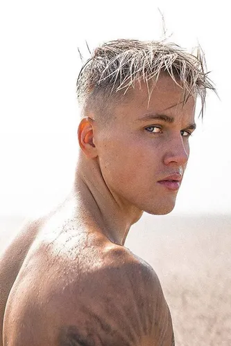 Try out this trendy short spiky hairstyle, wet from being at the beach, adding to its edgy appearance.