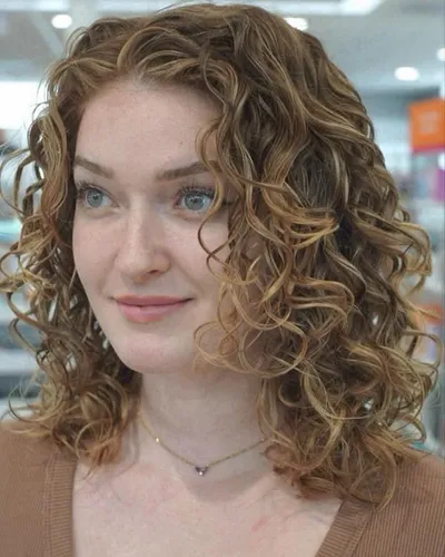 Try on this curly hairstyle, featuring tightly coiled curls that add texture and volume, flowing past the shoulders in a lively, dynamic arrangement